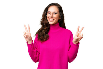 Young caucasian woman isolated over isolated background showing victory sign with both hands