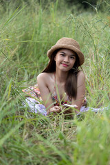 asian girl wearing a hat on the grass