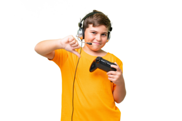 Little caucasian kid playing with a video game controller over isolated chroma key background showing thumb down with negative expression