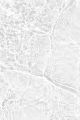 White water with ripples on the surface. Defocus blurred transparent white colored clear calm water surface texture with splashes and bubbles. Water waves with shining pattern texture background.