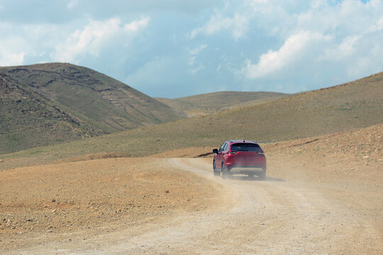 A red SUV off roading in the desert 