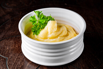 Fresh creamy mashed potato in white bowl on table