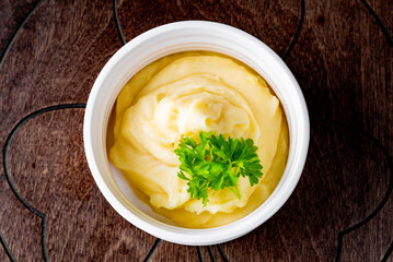 Fresh creamy mashed potato in white bowl on table
