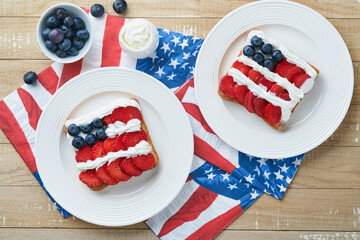 4th of July American Independence Day food. American flag sandwich with strawberries, blueberries,...