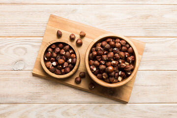 Wooden bowl full of hazelnuts on table background. Healthy eating concept. Super foods