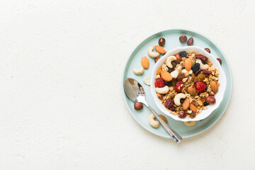 Cooking a wholesome breakfast. Granola with Various dried fruits and nuts in a bowl. The concept of a healthy dessert. Flat lay, top view with copy space