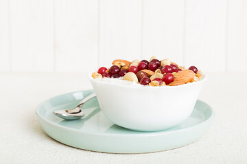 Healthy breakfast food with granola, yogurt, fruits and nuts. Dessert parfait with dried fruits for breakfast