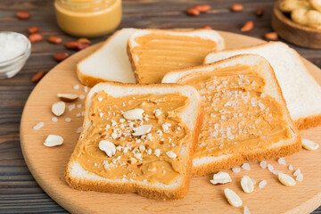 Peanut butter sandwiches or toasts on light table background.Breakfast. Vegetarian food. American cuisine top view vith copy space