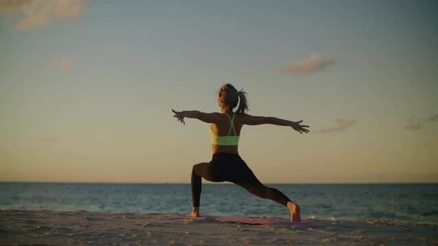 Woman yoga at sunrise, the girl stretches in harmony with the body and nature.