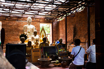 Ancient antique buddha in ruin old ubosot of Wat Khun Inthapramun temple for thai people traveler...