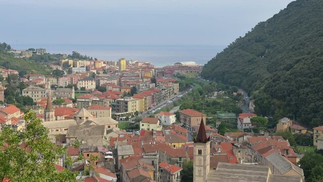 Amazing tilt footage from the hill overlooking Finalborgo, Liguria, Italy. In the landscape on the right, the bell tower and the historic village. In the distance the Ligurian Sea.