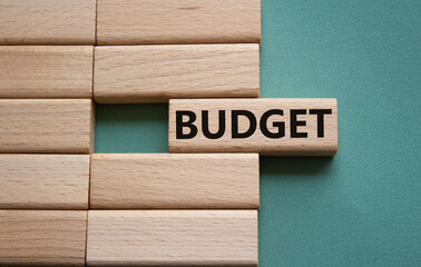 Budget symbol. Concept word Budget on wooden blocks. Beautiful grey green background. Business and Budget concept. Copy space.