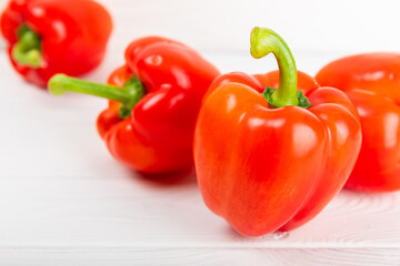 Fresh colorful red bell pepper on white textured wooden background. Bell pepper. Vegetables. Vegan food. Healthy foods. Place for text. Place to copy. Diet concept.