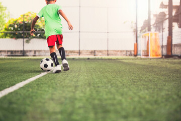 Obraz premium Soccer ball tactics children control the ball on a grass field for the training