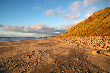 Rhossili Bay curves along an arc running northwards from the village. The sandy beach is 5 km long and is backed with sand dunes leading into Llangennith Sands. Burry Holmes is in the distance.