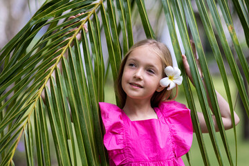 Candid lifestyle portrait of cute little Caucasian girl nine years old with blonde hair in stylish...