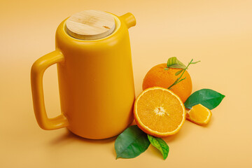 Orange tea in ceramic tea pot with ripe fruits. Refreshment seasonal drink, conceptual background