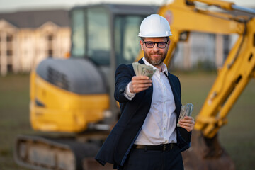 Buider man in suit and hardhat. Construction investor. Business man investor in front of...