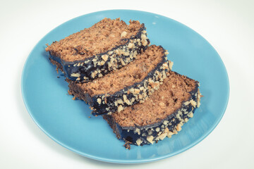 Pastry made of zucchini with nuts and raisin. Delicious dessert. White background