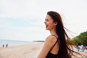 Naklejka premium woman summer sun smile vacation sand young ocean nature beach sea