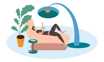 Fototapeta premium Creative man looking for inspiration while lying in an easy chair with a laptop