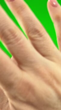 on green background chromakey female hands deny something closing picture sharply with both hands woman shows heart with hands with french manicure