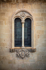 Beautiful renaissance twin window with intersecting semicircular arches and slender column of the...