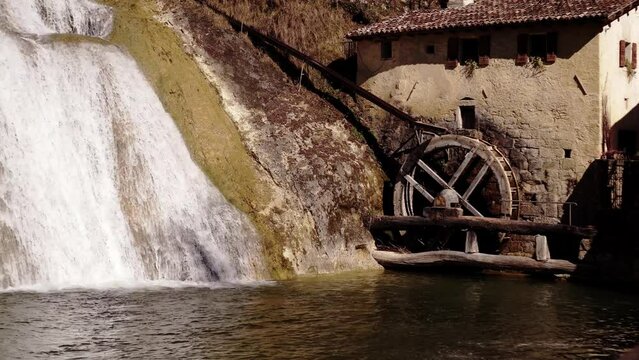 Mill with the wheel stopped near a waterfall