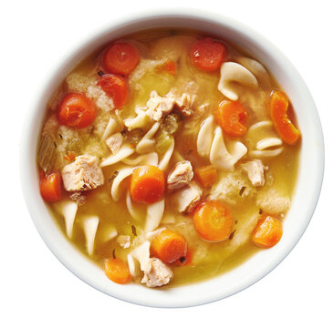 top down photo of chicken noodle soup in bowl on isolated transparent background