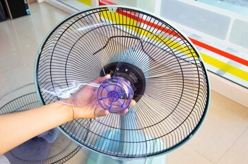 Technician repairing fan, replacing impeller