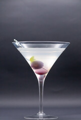 Tempting Twist: Martini with Luscious Cherry Garnish Steals the Show with flamingo pick on side of glass isolated on black background