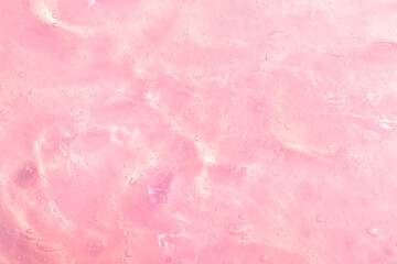 Cosmetic gel, serum transparent sample. Liquid cream with bubble texture. Gel texture of a cosmetic product. Clear liquid lotion for skin care.