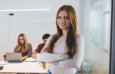 Happy woman in office with coworkers