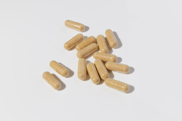 Herbal organic capsules on the white background. Natural supplements for healthy good life.