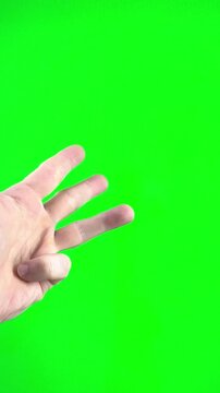 male hand on green background chromakey close-up starts counting from 1 to 5 First he shows thumb up then kneads five fingers