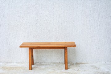 Wood bench with white wall for background texture concept.