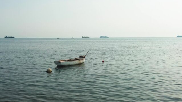 A lonely boat floating in a hot summer day
