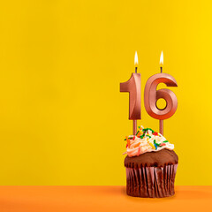 Candle with flame number 16 - Birthday card on yellow background