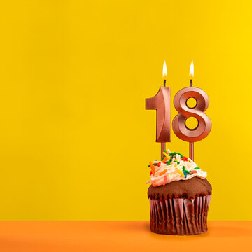 Candle with flame number 18 - Birthday card on yellow background