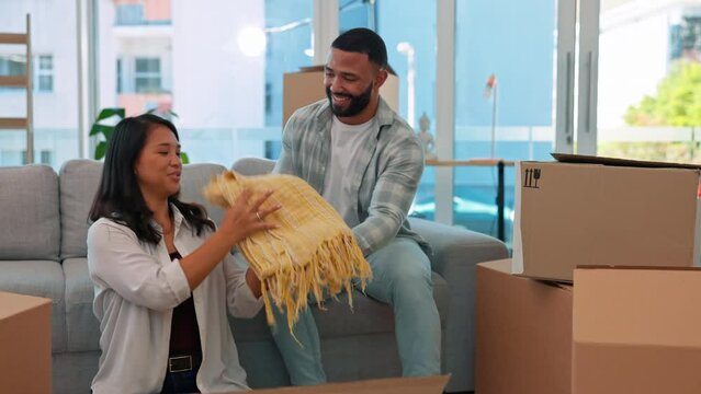 Couple, moving and packing box in home for real estate, relocation and property housing. Man helping woman with cardboard boxes, pillow and blanket for move to new house, apartment and investment