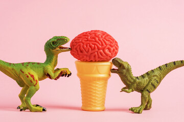 Funny green dinosaurs eating ice cream in shape of human brains on waffle cone on pink background.