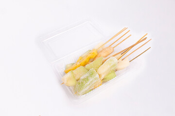 fruit skewered on mica on a white background