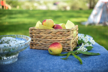 Small straw basket filled with red ripe apples
