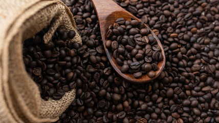 Roasted coffee beans with scoop and jute cover