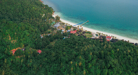 Aerial drone view of lush green island scenery with at Tinggi Island or Pulau Tinggi in Mersing, Johor, Malaysia