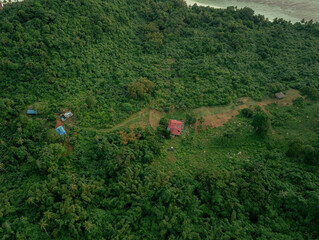 Aerial drone view of lush green island scenery with at Tinggi Island or Pulau Tinggi in Mersing, Johor, Malaysia