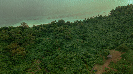 Aerial drone view of lush green island scenery with at Tinggi Island or Pulau Tinggi in Mersing, Johor, Malaysia