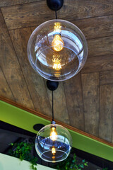 glass lampshades and incandescent bulbs on the ceiling in the cafe.