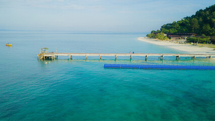 Aerial drone view of coast scenery with blue sea water at Tinggi Island or Pulau Tinggi in Mersing, Johor, Malaysia
