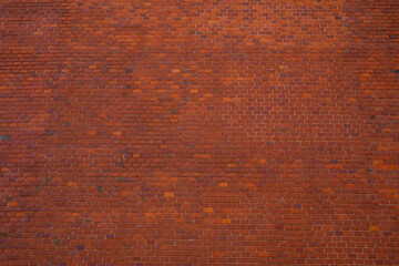 Big brick wall made of orange and red bricks as part of outer wall of Wawel castle in Krakow,...